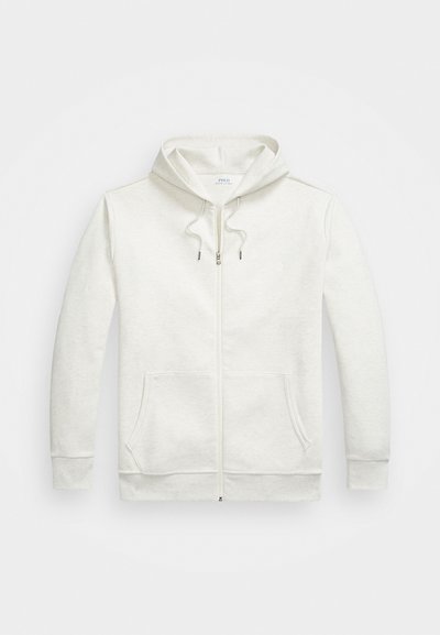 Ανοιχτό γκρι ζακέτα με φερμουάρ φτιαγμένη από μαλακό ύφασμα. Διαθέτει κουκούλα με κορδόνι, μπροστινές τσέπες και ένα μικρό λογότυπο στο στήθος.