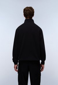 Black pullover, featuring a high collar, ribbed cuffs, and a relaxed fit. Made from smooth, solid fabric with no visible patterns.