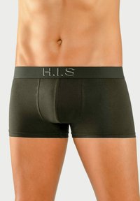 Temnozeleni bokserji z elastičnim pasom, na katerem je logotip "H.I.S.". Gladka tekstura in prilegajoča zasnova poudarjata obliko.
