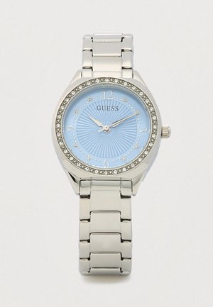 Silver Guess watch with a light blue dial, embellished with crystals and a textured background. Features a stainless steel bracelet.