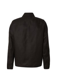 Veste noire à manches longues avec un dos droit, col chemise et poignets boutonnés, vue de dos.
