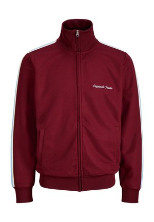 Bordó cipzáras sportdzseki bordázott mandzsettákkal és szegéllyel, világoskék és bézs csíkokkal az ujjakon, valamint "Originals Studio" felirattal a bal mellrészen.