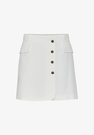 Valge seelik, millel on kuus pruuni nuppu ees, kaks küljetaskut ja kergelt A-line disain. Sile kangas, millel on minimaalne tekstuur.