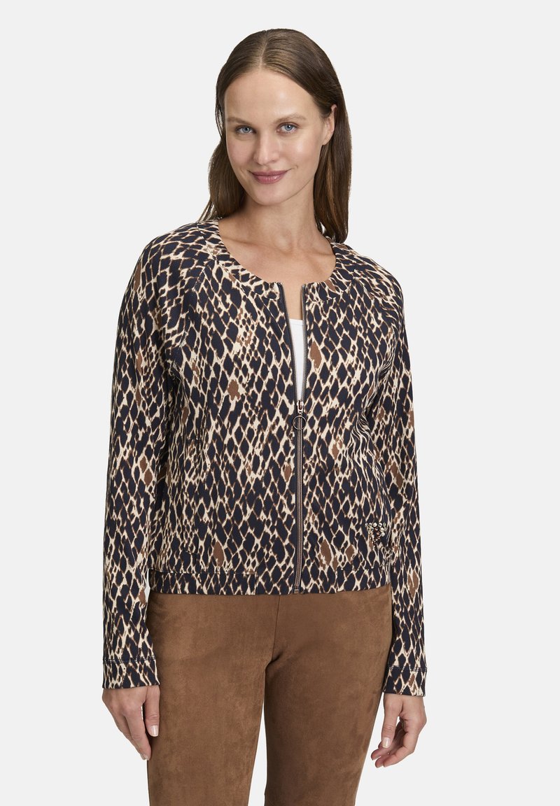 Veste zippée à motifs avec un imprimé léopard en marron et bleu marine, dotée d'un col rond et de manches longues ; tissu doux et texturé.