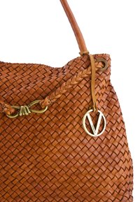 Brown woven leather handbag with braided handle and gold-tone Venezia logo charm on white background.
