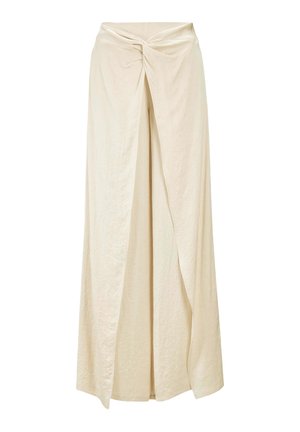 Cream-colored maxi skirt made of lightweight fabric, featuring a twisted front design and a flowy silhouette with a long slit.