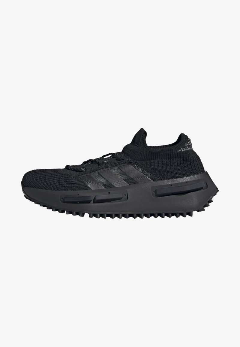 Black athletic shoe with a knitted upper, featuring three dark stripes, a thick rubber sole, and textured grip for traction.