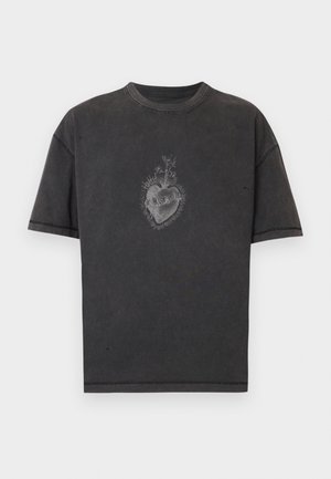 Μαύρο βαμβακερό T-shirt με χαλαρή εφαρμογή, με γραφικό σχέδιο στην κορυφή που απεικονίζει μια καρδιά με λουλούδια και κρανία στο κέντρο. Ορατή λεπτομέρεια ραφής.