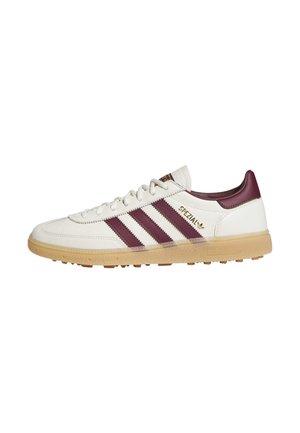 White Adidas Spezial sneaker with burgundy stripes, heel tab, gum sole, and gold lettering on the side.