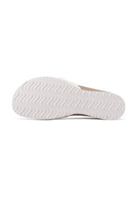 Soletta delle calzature con una superficie in gomma bianca testurizzata caratterizzata da un motivo ondulato, completata da una parte superiore in suede marrone.