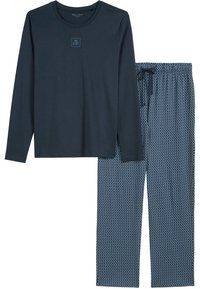Middengroene langekleurige top met klein borstlogo en blauwe drawstring pyjamabroek met patroon.