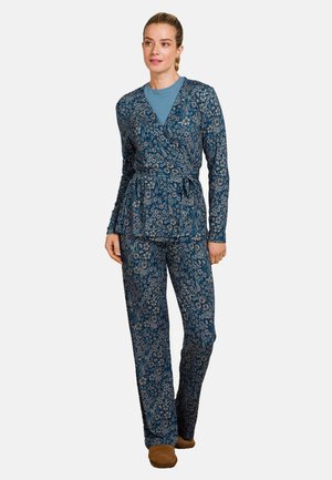 Langärmlige Wickeloberteil und passende Hose in Marineblau mit Blumenmuster. Leichte Stoff, Taillengürtel und lockere Passform. Bequeme Fußbekleidung inklusive.