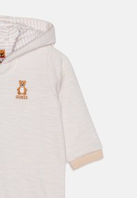 Guess NEW BORN PADDED HOODED UNISEX - Overal - sand grain