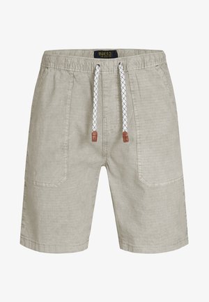 Világos bézs színű, texturált anyagból készült rövidnadrág, húzózsinórral ellátott derékkal és mintás zsinórokkal, valamint két oldalsó zsebbel.