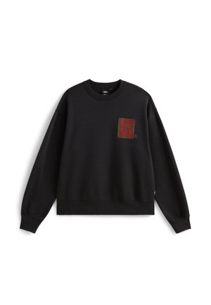 Sweatshirt noir à col rond et manches longues. Présente un logo Vans brodé en vert et rouge dans le coin supérieur gauche. Texture douce.