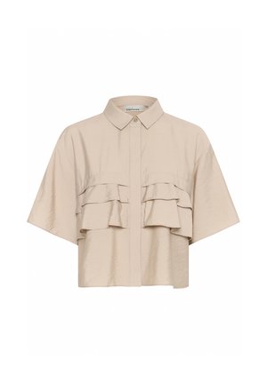 Bežová košeľa s krátkym rukávom a zapínaním na gombíky, ktorá má dva horizontálne volány na hrudi a jemnú, hladkú textúru.