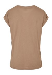 Kortärmad, ljusbrun t-shirt gjord av mjukt tyg, med en lös passform och rullade ärmslut, rund halsringning och sidslitsar.