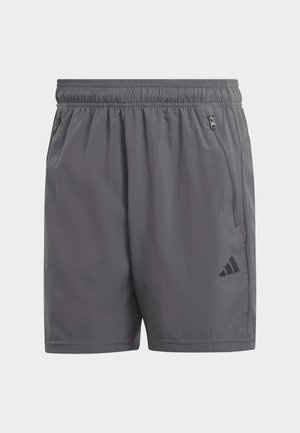 Grå løbeshorts med elastisk talje, sidelommer med lynlås og et sort logo-aksent. Letvægts, glat tekstur og knælang.