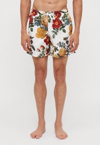 Costumi da bagno floreali con una base bianca e fiori multicolori, vita elasticizzata e chiusura con cordino.
