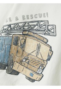 Embroidered fire truck design in beige, blue, and gray on a white background, featuring detailed textures and a ladder above.