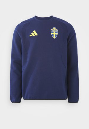 Námořnická modrá mikina s kulatým výstřihem, dlouhými rukávy a texturovanými ramenními panely. Obsahuje žluté logo Adidas a erb Švédska.