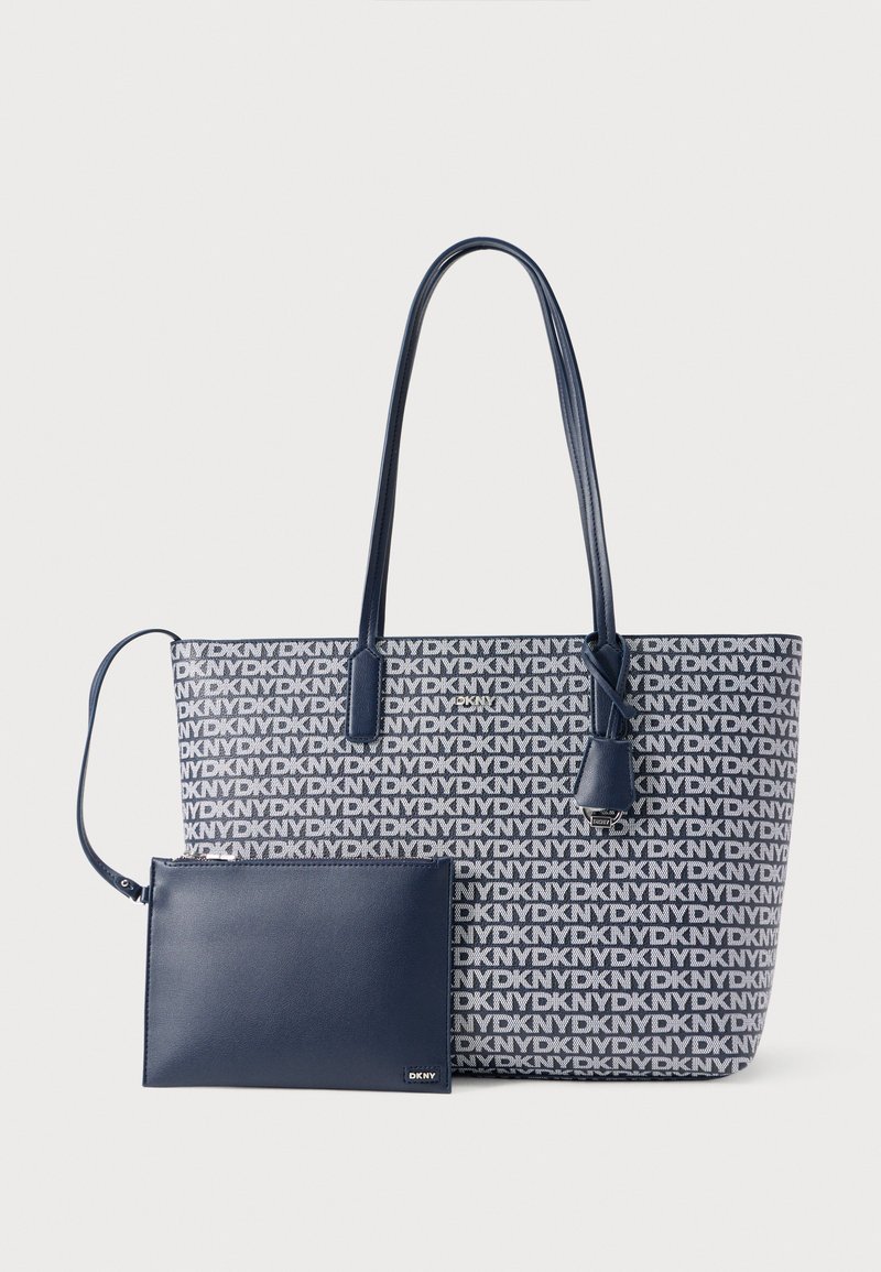 Torba na ramię w niebiesko-białym wzorze z logo z długimi uchwytami; zawiera dopasowaną granatową saszetkę na zamek. Gładka faktura i usztywniony kształt.