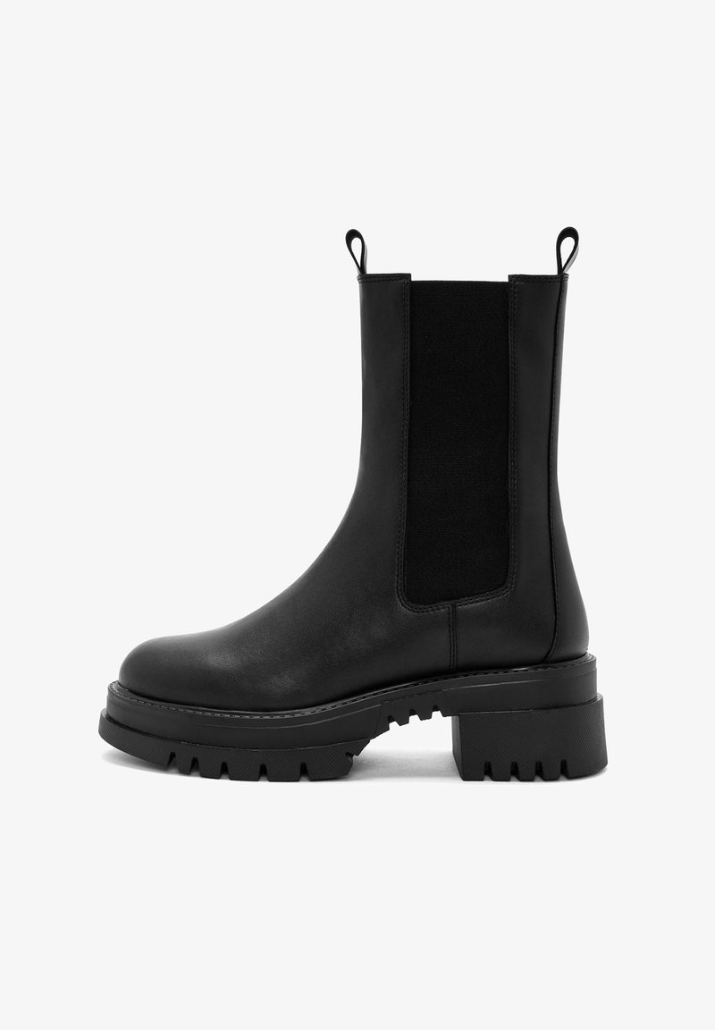 Black leather ankle boot with elastic side panels, pull tabs, chunky sole, and textured tread. Smooth finish and robust design.