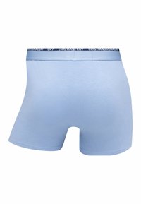 Light blue boxer shorts made of soft fabric, featuring a dark waistband with "CR7" and "Cristiano Ronaldo" text. Smooth texture, fitted design.
