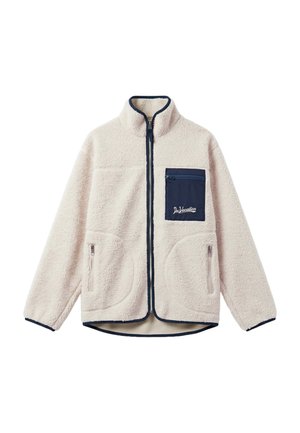 Veste polaire crème avec bordure marine, fermeture éclair sur le devant, deux poches latérales zippées et une poche poitrine zippée marine portant l'étiquette "Dr Vacation."