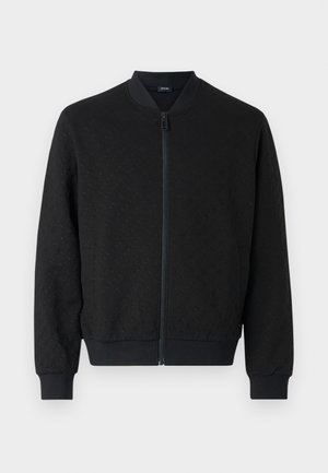 Svart bomberjakke med teksturert stoff, ribbede mansjetter og linning, full glidelås og rund krage. Enkelt, moderne design.