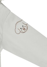 Light gray sweatshirt featuring a soft, embroidered bear face on the left sleeve. Smooth fabric with a casual design and comfortable fit.