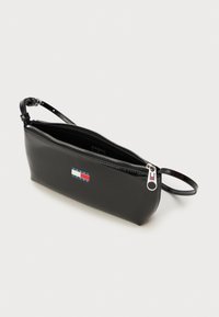 Black leather clutch with a zip closure, wrist strap, and a logo patch featuring red, white, and blue stripes on a rectangular background.