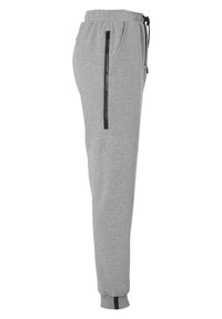 Grijze sweatpants met een taps toelopende pasvorm, elastische tailleband, trekkoord en ritszakken aan de zijkant. Glad materiaal met contrasterende zwarte accenten.