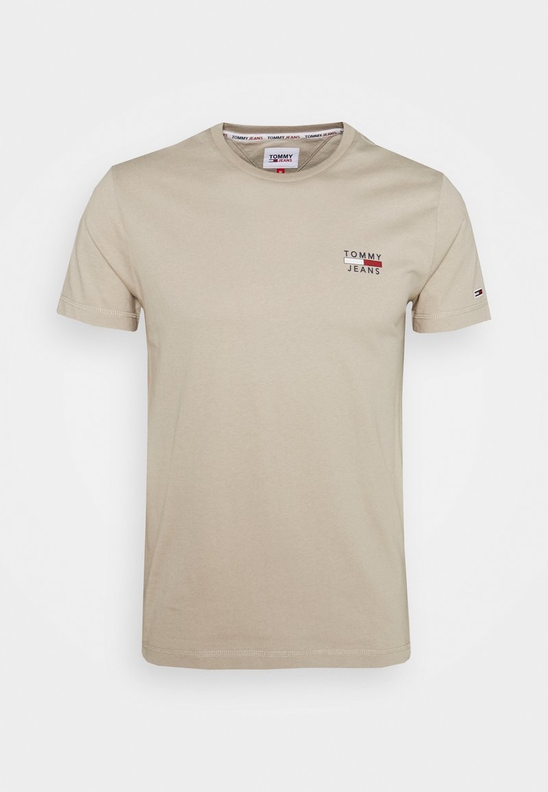 Beige puuvillane t-särk lühikeste varrukatega, ümar kaelus ja rindkere peal väike punane ja sinine "Tommy Jeans" logo. Tavaline lõige.