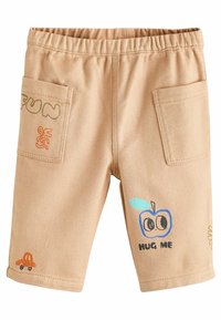 Béžové bavlnené šortky s elastickým pásom, s vizuálnymi vzormi: grafiky "ZÁBAVA" a "OBJÍM MA", plus malá ilustrácia oranžového auta.