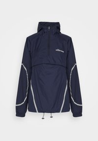 Marinblått tröja med huva, halvdragkedja fram och reflekterande detaljer på ärmar och sidor. Tillverkad av lätt, vattentätt material.