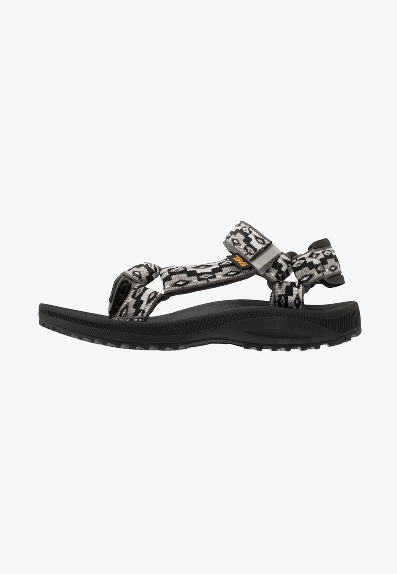 Black and gray patterned sandal with adjustable straps, rubber sole, and textured footbed for grip and comfort. Features a buckled strap.