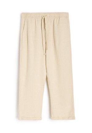 Beżowe lniane spodnie dresowe z elastycznym pasem i sznurkiem. Posiadają boczne kieszenie oraz podwinięte mankiety przy kostkach.