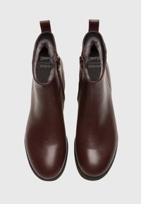 Burgundy leather ankle boots with a smooth finish, featuring a side zipper and cushioned interior lining. GORE-TEX for waterproofing.