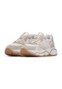Beige athletic sneakers with a mix of suede and mesh materials, featuring a textured rubber sole and subtle metallic accents.