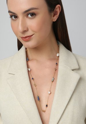 Gold-tone necklace featuring a mix of blue and turquoise beads, interspersed with white pearls and gold accents, hung on a delicate chain.