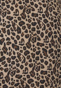 Leopardprintstof met een beige achtergrond en zwarte en bruine vlekken in verschillende vormen en maten, met een gladde textuur.