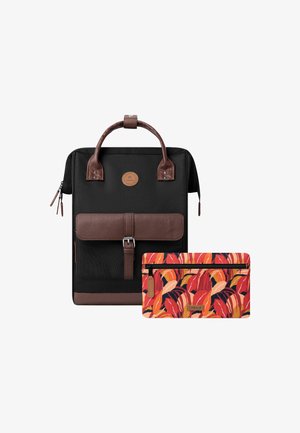 Black canvas backpack with brown leather accents, featuring a front flap and a matching colorful zippered pouch with floral pattern.
