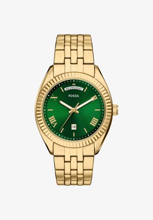 Horloge van metaal met goudkleurige tint, groene wijzerplaat, Romeinse cijfers, dagvenster om 12 uur, datumvenster om 6 uur en driewijzersbeweging.
