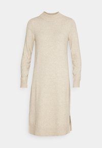 Beige koftaklänning med hög krage, långa ärmar och ribbade manschetter. Har en rak skärning och sidofickor för ökad rörelsefrihet.