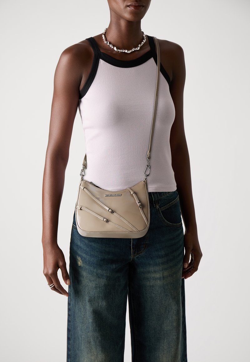 Borsa a tracolla beige con motivo diagonale testurizzato, accorgimenti in argento e tracolla regolabile. Il materiale sembra liscio e lucido.