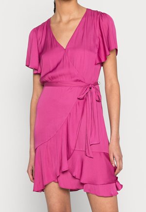 Woman wearing bright pink wrap dress with flutter sleeves, V-neck, tied waist, and layered ruffle hem, shown from neck to mid-thigh.