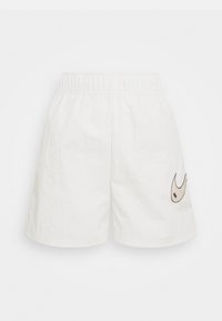 White shorts with an elastic waistband, made of lightweight material. Features a decorative logo in beige on the left leg.