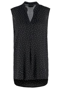Blusa nera senza maniche con colletto, decorata con pois bianchi, con chiusura frontale e orlo curvo. Texture di tessuto liscia.