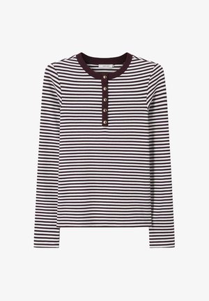 Chemise côtelée manches longues avec fines rayures horizontales noires et blanches et une patte de boutonnage noire avec cinq boutons au col avant.